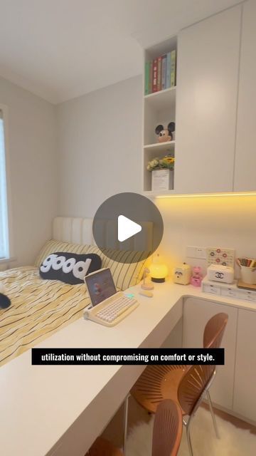 a room with a bed, desk and laptop on the table in front of it