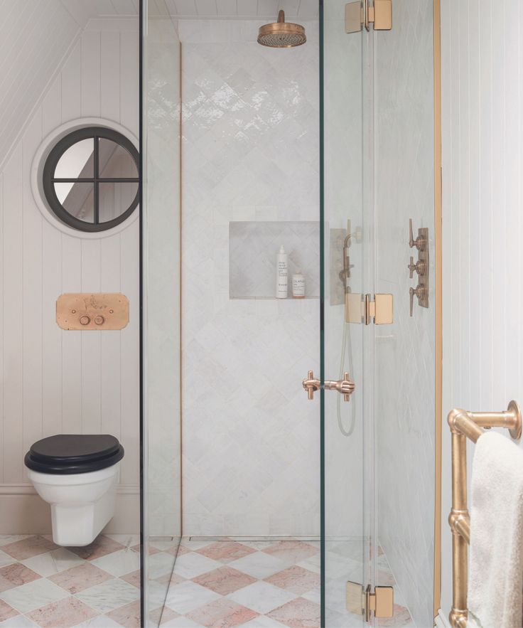 a bathroom with a toilet and shower in it