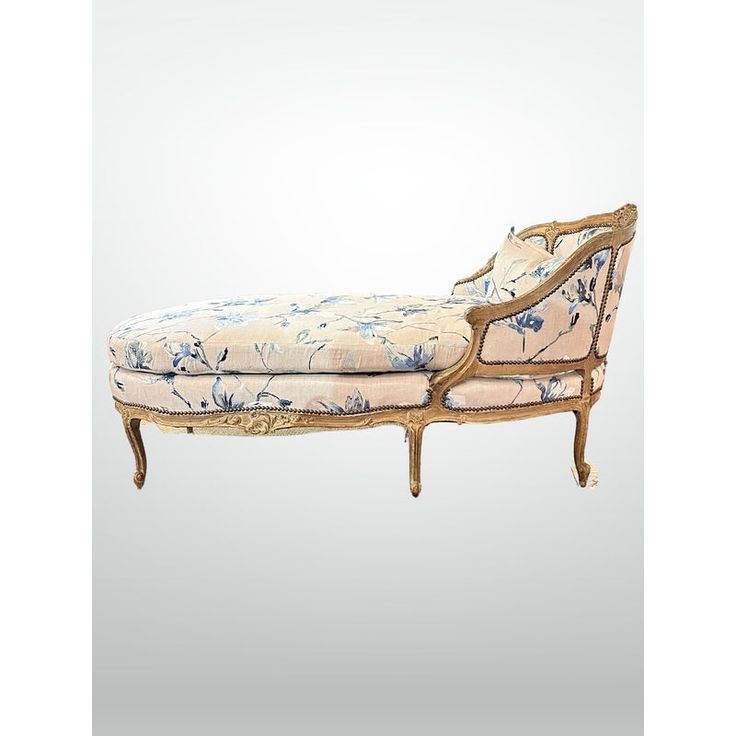 an antique chaise lounge with floral upholstered fabric