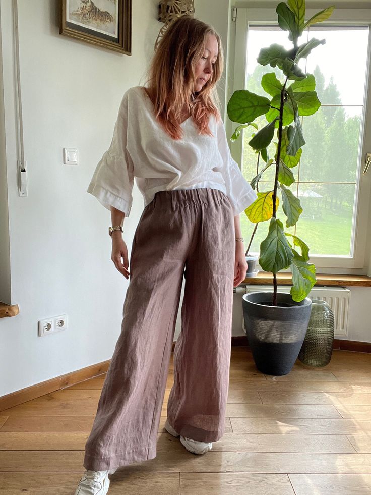 This super comfy loose fitting elasticated pants are made of softened European 100% linen.  They are great for a casual style all day long summer days.  Very classic and practical summer colour. It has got 2 pockets on the sides. It is the ultimate fabric for hot weather as it breathes and absorbs moisture better that any fabric on earth. Please write me a note if you would like any other colour from our fabric options, using a number or a name of a colour of your choice. Please write if you nee Baggy Linen Bottoms For Vacation, Summer Brown Relaxed Fit Pants, Brown Relaxed Fit Pants For Vacation, Neutral Wide Leg Pants For Beach, Baggy Linen Beach Pants, Bohemian Baggy Linen Pants, Baggy Linen Bohemian Pants, Brown Baggy Linen Bottoms, Spring Wide-leg Flax Pants