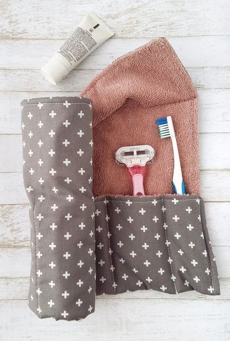 a pink toothbrush in a pouch next to a towel