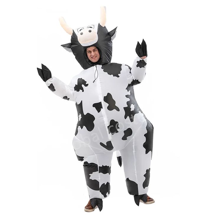 a man in a cow costume is standing with his arms out and legs spread wide