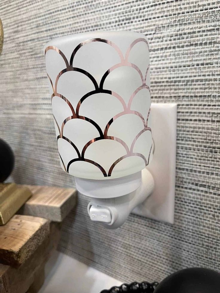 a white toilet paper dispenser mounted to a wall