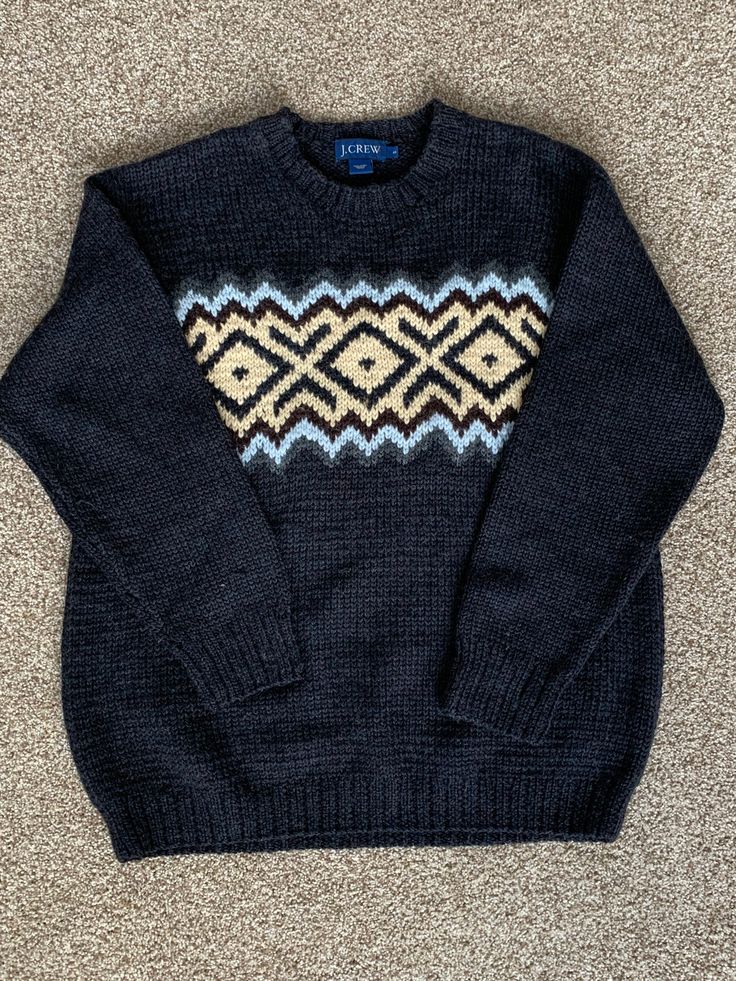 Excellent condition on this vintage small large wool sweater I can't decide if it's very dark gray or black.. but a great vintage sweater either way Classic Winter Sweater With Fair Isle Pattern, Classic Fair Isle Sweater For Winter, Classic Fair Isle Winter Sweater, Black Wool Sweater With Fair Isle Pattern, Black Wool Polo Sweater For Fall, Classic Fitted Fair Isle Sweater, Brown Crew Neck Polo Sweater For Winter, Warm Wool Sweater For Winter Wear, Warm Wool Winter Sweater