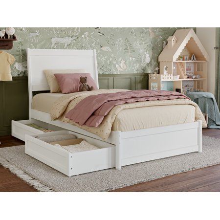 a white bed sitting on top of a wooden floor next to a dresser and chest