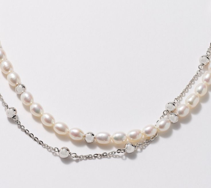 Classic cultured freshwater pearls or sleek sterling silver chain? This double strand necklace gives you a beautiful blend of both looks, combined with polished sterling silver beads to complete the elegant design. From Honora. Sterling Silver Beaded Pearl Necklace, Elegant Jewelry With Double Chain And Round Beads, Silver Dainty Beaded Pearl Necklace, Dainty Silver Beaded Pearl Necklace, Silver Double Strand Pearl Necklace Gift, Elegant Double Strand Pearl Necklace With Beaded Chain, Silver Multi-strand Pearl Necklace, Elegant Double Strand Silver Pearl Necklace, Silver Pearl Necklace With Double Chain