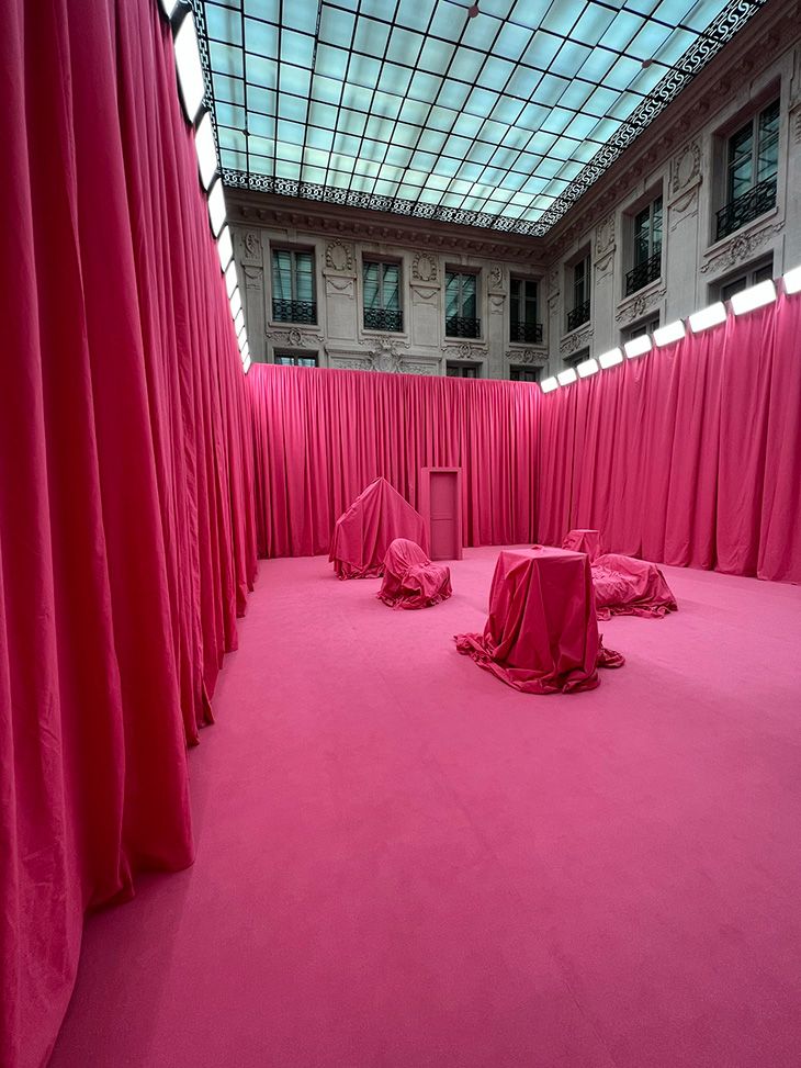 the room is covered with pink curtains and drapes for covering it's walls