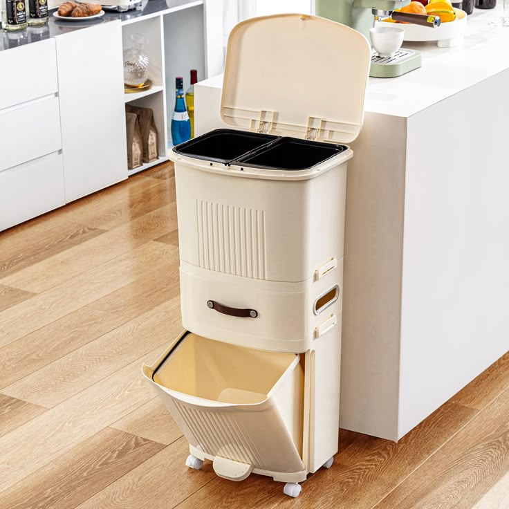 a large white trash can sitting on top of a hard wood floor next to a kitchen counter