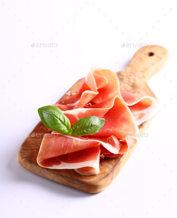 raw meat with basil on wooden cutting board - stock photo - images