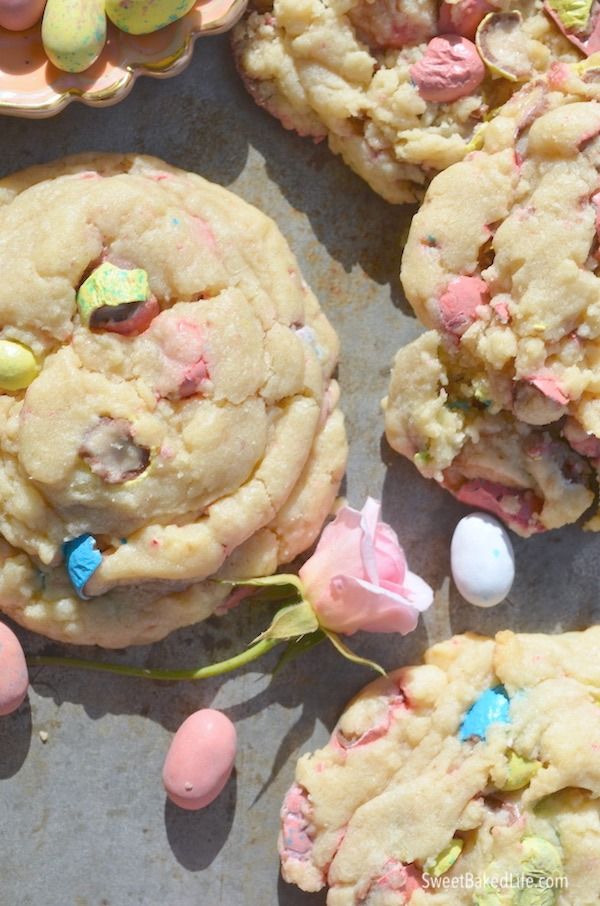 several cookies with candy and candies scattered around them