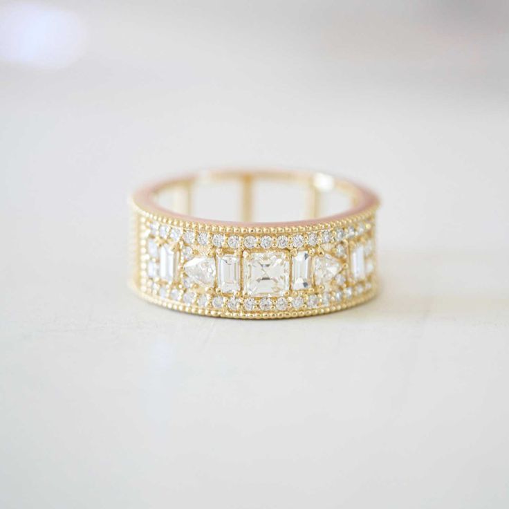 a gold ring with white stones on it