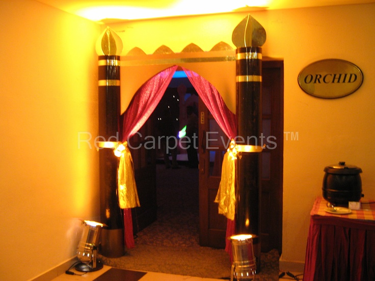 the entrance to an event with red and gold drapes