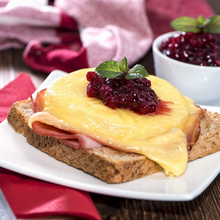 a piece of bread with jam and cheese on it