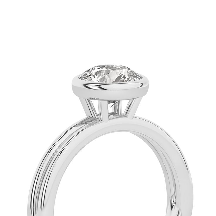 Crafted with exquisite detail, this Coupled Round Bezel Ring features a brilliant round lab-grown diamond nestled within a unique dual-band design. One band gleams in lustrous white gold, while the other elegantly contrasts in either romantic rose gold or striking yellow gold. All white gold option is also available. This solitaire diamond ring perfectly blends contemporary sophistication and classic charm, making it an ideal choice for engagements, anniversaries, or simply as a symbol of enduri Refined Diamond Ring With Center Stone, Refined Round Diamond Ring With Center Stone, Luxury Round Halo Solitaire Ring, Luxury Solitaire Halo Ring, Luxury Halo Solitaire Ring, Refined Round Cut Jewelry With Tension Setting, Timeless Halo Ring With Prong Setting, Diamond Solitaire Halo Ring, Classic Round Halo Ring With Lab Grown Diamond