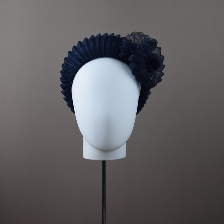 From our UNIQUE COLLECTION this very flattering halo crown style is very much in vogue this season. This one has been hand blocked and wired using traditional millinery techniques. Formed from navy sinamay straw and overlaid with pleated crin.  A sculptural rose adorns one side. ONE OF A KIND - READY TO SHIP  UK - STANDARD DELIVERY  1-2 DAYS           EXPRESS NEXT DAY  INTERNATIONAL  -STANDARD DELIVERY  5-10 DAYS                                    EXPRESS 3-4 DAYS CHOOSE DELIVERY METHOD AT CHECK Blue Structured Crown Headpiece For Party, Blue Adjustable Headband Costume Hat, Adjustable Blue Headband Costume Hat, Adjustable Blue Costume Headband, Blue Structured Crown Headpiece For Evening, Blue Adjustable Headpiece With Pinched Crown, Adjustable Blue Headpiece With Pinched Crown, Elegant Fitted Crown Headpiece, Blue Headband For Party