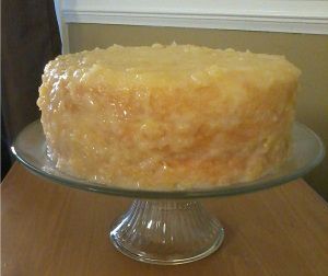 a close up of a cake on a glass plate with a wooden table in the background