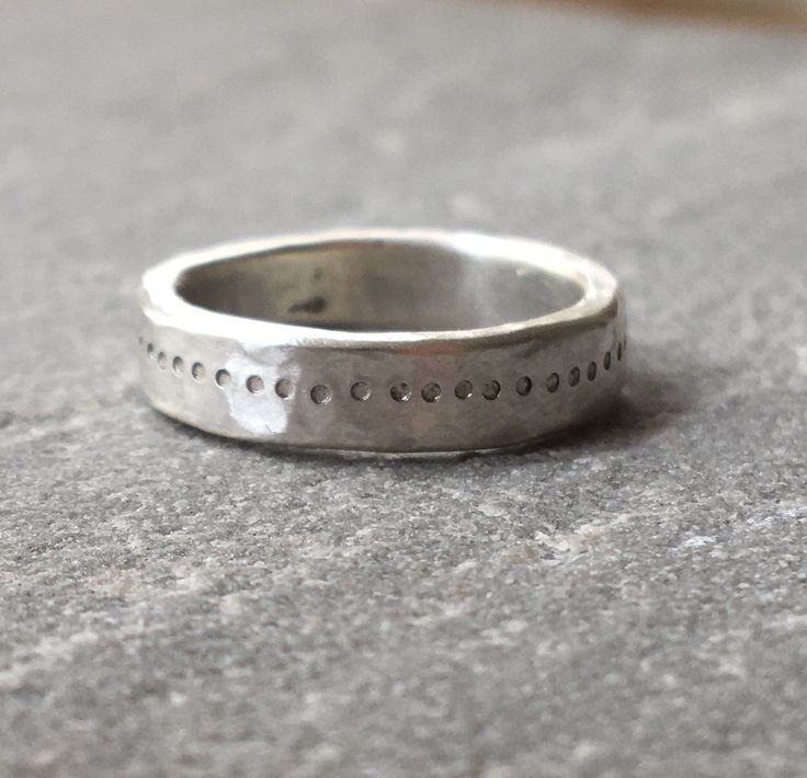 A great chunky ring with a free hand stamped ring of dots going all the way around. The silver has a hammered rough luxe texture from being beaten into shape. Comfortable to wear and strong enough for everyday. Perfect as an alternative silver wedding band if desired. Due to the making process each ring is unique so please allow for some variation as your ring will be made to order. Please send your ring size when ordering. The video shows the ring with a flush set pink sapphire, please message Thick Silver Ring, Silver Hammered Ring, Small Silver Hoop Earrings, Minimalist Silver Ring, Chunky Silver Rings, Hand Stamped Ring, Hammered Silver Ring, Stamped Rings, Hammered Ring