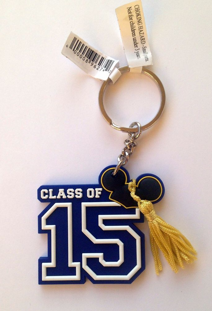 a blue and white keychain with a yellow tassel hanging from it's side