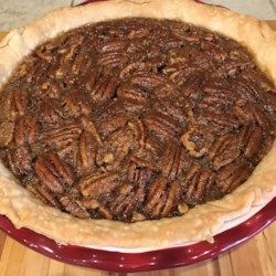 a pecan pie sitting on top of a wooden table