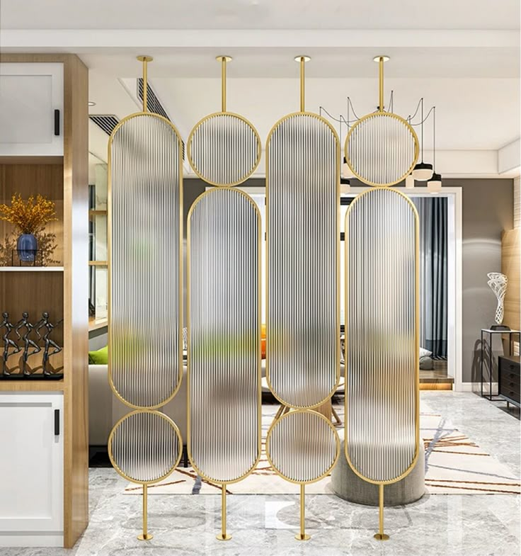 a room divider in the middle of a living room with white and gold decor