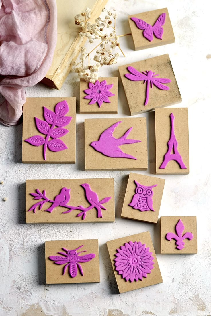 stamping supplies are laid out on a table with flowers, birds and other items