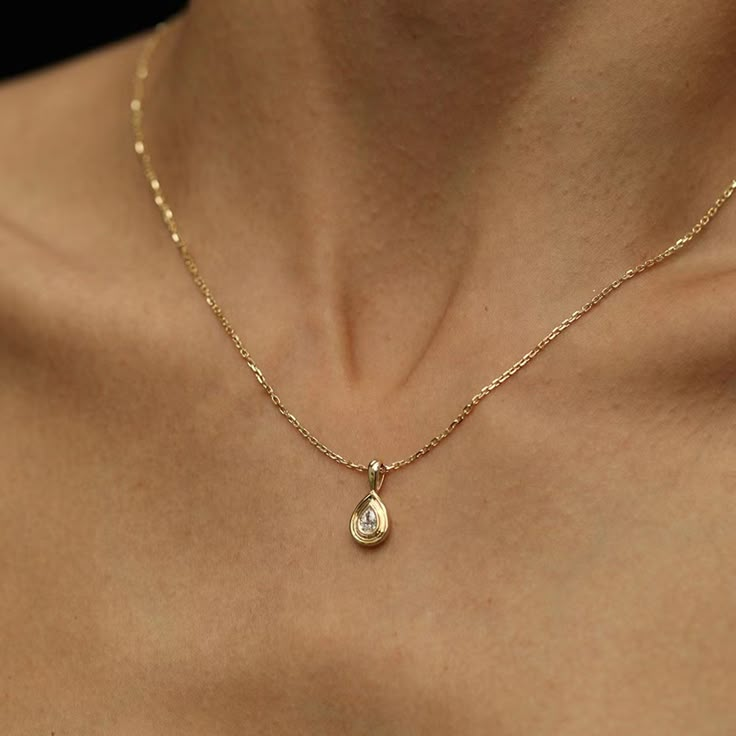 "14K Gold Pear Cut Diamond Solitaire Pendant ---DETAIL--- Center Stone: Diamond Origin: Ethically Sourced Lab Grown Size: 5.8x3.0mm approx. Cut: Pear Color: F-G Clarity: VS1 Carat: 0.30CT Total Carat: 0.30CT Pendant size: 15mm in length Chain: 14K Gold 1mm cable chain Length: 16.5\" Every piece that main stone is over 1.00 carat will come with an IGI certificate and a jewelry appraisal. We do custom rings according to your preferences and budget in any size, color, and clarity of lab-grown diamonds combined in 14K, 18K gold, or Platinum. Please contact us for more details." Luxury Yellow Gold Teardrop Necklaces, Piaget Sunlight Necklace, Luxury Dainty Lab Grown Diamond Jewelry, Pear Cut Diamond Necklace, Gold Teardrop Jewelry With Bezel Setting, Pear Diamond Pendant, Everyday Teardrop Jewelry With Bezel Setting, Gold Drop Necklace With Bezel Setting, Gold Drop Necklace With Birthstone