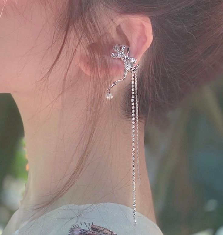 Sparkling no piercing silver ribbon ear cuff climber, with pearl and rhinestone dangles. Stylish punk street wear style, super chic and edgy. No ear hole necessary, easy to wear and adjust. Delicate cubic zircon paved on cute silver ribbon. Absolutely unique add on to your everyday outfit! , 💎 Features: ♥ Material: Silver plated copper ♥ Main stone: Faux pearl ♥ Side Stone: Rhinestone ♥ Adjustable ear cuff, no ear hole needed ♥ Sold as 1 piece 💎 Details: ♥ Approximate Measurements: - Length: 7.5 cm - Width: 2.3 cm ♥ Lightweight, easy to wear ♥ Nickel/Lead Free, Hypoallergenic, good for sensitive skins 🎁 Packing & Shipping: ♥ All our jewelry will be shipped with beautiful gift wrap packaging ♥ Handwrite gift notes/cards available upon request ♥ SAME DAY& FREE US Domestic Shipping availab Elegant Dangle Ear Cuff For Party, Silver Ear Climbers For Party, Elegant Sterling Silver Clip-on Ear Cuff, Dangle Ear Cuff For Party With Matching Earrings, Party Dangle Ear Cuff With Matching Earrings, Silver Dangle Ear Cuff For Party, Silver Cubic Zirconia Ear Cuff For Party, Party Ear Cuff With Matching Earrings, Elegant Ear Climbers For Party