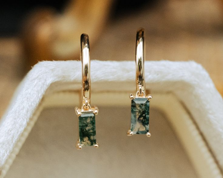 These delicate earrings are crafted with meticulous attention to detail. The focal point is the mesmerizing moss agate gemstones, each possessing a unique landscape of moss-like inclusions reminiscent of a miniature forest captured in stone. The moss agate stones, polished to a gentle sheen, exude a serene, organic beauty, with hues ranging from deep greens to translucent whites, evoking the tranquil essence of nature. Whether worn for a special occasion or to add a touch of elegance to everyday Moss Agate Earrings, Ring Board, Miniature Forest, Womens Matching Sets, Moss Agate Jewelry, Staghead Designs, Earrings Stone, Antique Gift, Agate Earrings