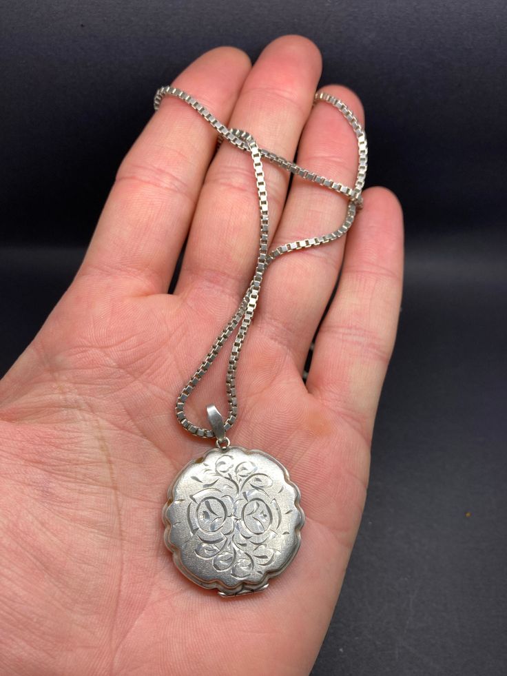 It is a English hallmarked, vintage, round, ornate, locket/pendant, with a silver chain, there is a silver hallmark on the clasp, weight 23 g, pendant height 4.2 cm, 3.2 cm diameter, chain is 55 cm long, in a good condition. Antique Round White Gold Necklace, Antique White Gold Round Necklace, Classic Silver Medallion Pendant Necklace, Classic Locket Necklace For Vintage Collection, Classic Silver Pendant Medallion Necklace, Vintage Charm Medallion Necklace Gift, Round Medallion Necklace With Vintage Charm As A Gift, Gift Medallion Necklace With Vintage Charm, Victorian Jewelry With Coin Pendant