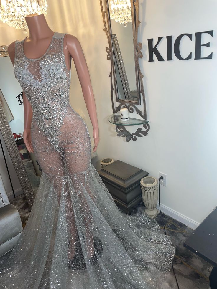 a mannequin is dressed up in a silver gown