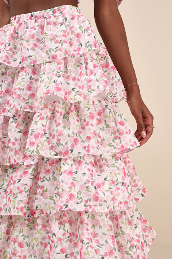 The ethereal elegance that emanates from the Sister Jane Wild Hearts Ivory Multi Floral Tiered Midi Skirt will have you feeling romantic all day long! A darling pink and green floral print, along with a subtle diamond-like jacquard pattern, adorns gauzy woven chiffon as it shapes this whimsical midi skirt. The high-waisted fit naturally flatters your figure, while layers of cascading tiers (with hidden tulle for additional volume) line the A-line silhouette to complete the adorable design. Hidde Flowy Ruffle Hem Skirt For Garden Party, Flowy Skirt With Ruffle Hem For Garden Party, Tiered Skirt With Floral Print For Garden Party, Tiered Floral Print Skirt For Garden Party, Feminine Floral Print Tiered Skirt, Flowy Ruffle Midi Dress, Flowy Ruffled Maxi Skirt For Garden Party, Feminine Maxi Skirt With Ruffle Hem, Garden Party Ruffled Maxi Skirt