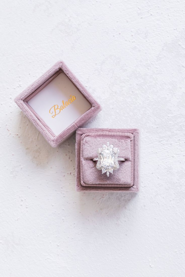 an engagement ring in a pink velvet box