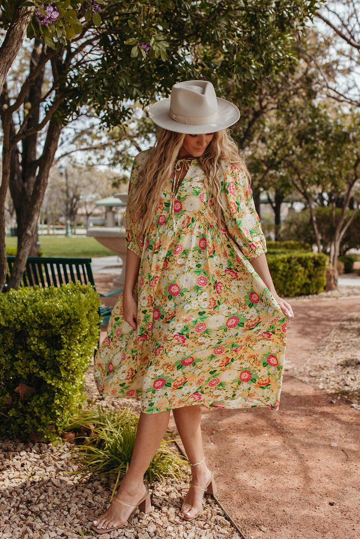 Add a pop of color to your wardrobe with our Aliyah Tie Front Puff Sleeve Midi Dress in Yellow. This beautiful dress features a playful tie detail, short sleeves, and a charming floral print. Perfect for a sunny summer day! Paired with THE GRETA PLATFORM LOAFERS IN BONE V-neck with tie string Midi length Puff sleeves Pockets Clean hem Lined Self: 100% Rayon, Lining: 100% Polyester Model is 5'5" wearing a small. Length (shoulder to hem): Small: 48”, Medium: 48.5”, Large: 49” To view our return po Casual Green Lemon Print Dress, Green Casual Dress With Lemon Print, Casual Green Dress With Lemon Print, Spring Yellow Midi Dress With Lemon Print, Retro Short Sleeve Midi Dress For Spring, Casual Yellow Puff Sleeve Midi Dress, Retro Midi Dress For Spring Day Out, Casual Yellow Puff Sleeve Dress, Yellow Short Sleeve Dress For Garden Party