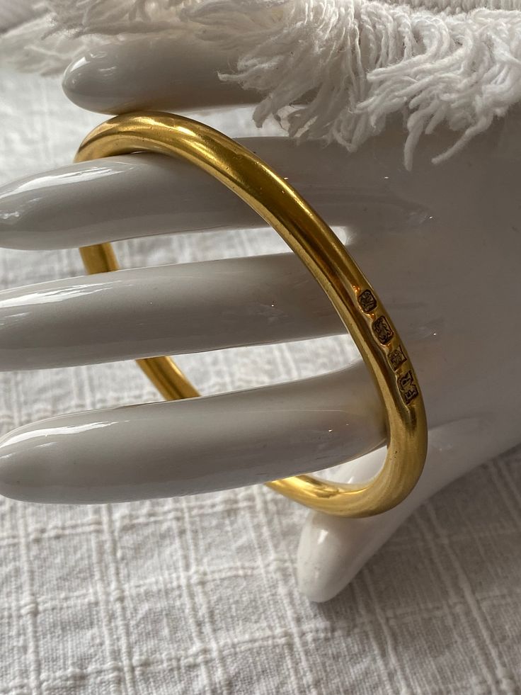 This is a lovely signed gold vermeil bangle bracelet, made in England. It is fully hallmarked , and in excellent, vintage condition. The bracelet is beautifully made, and weighs 60g. The bracelet measures 7 5/8 inches inside. It is perfect for a larger wrist. It is stylish and appropriate for a male or female. This bracelet was made in England in 1941. Multiple hallmarks. "14k gold vermeil over sterling silver. Impressed anchor and lion assay mark with maker's mark FR and capital letter script R Gold Bangle Stamped 14k As Gift, Timeless Gold Cuff Bracelet For Everyday Wear, Everyday Gold Timeless Cuff Bracelet, Formal Yellow Gold Brass Bracelets, Heirloom Style Polished Gold Bangle, Classic Gold Jubilee Bracelet In Brass, Classic Gold Bracelet Bangle In Brass, Classic Gold Brass Bangle Bracelet, Classic Brass Gold Jubilee Bracelet