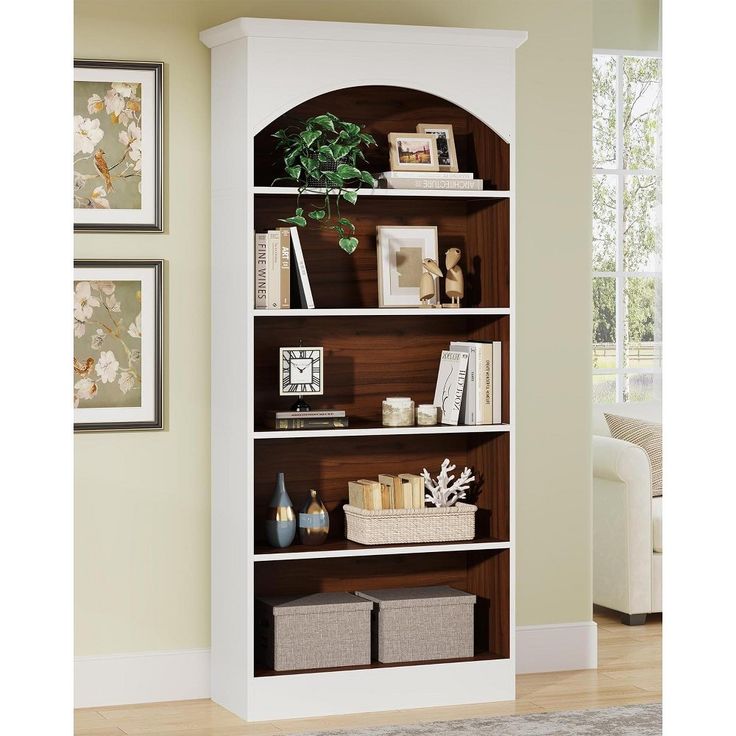 a white bookcase filled with lots of books