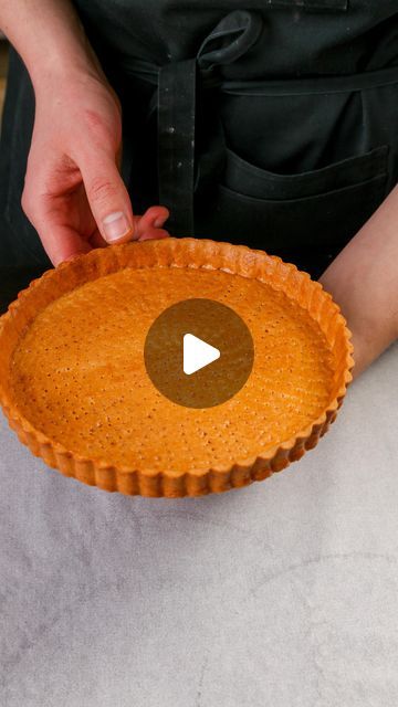 a person holding a pie in their hand