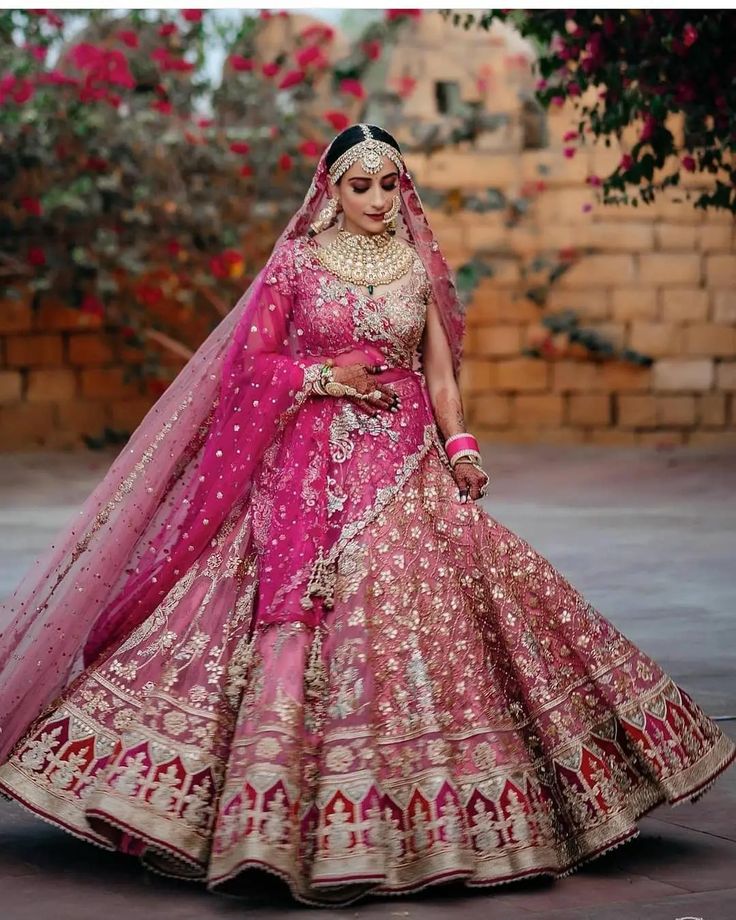 a woman in a pink and gold bridal gown