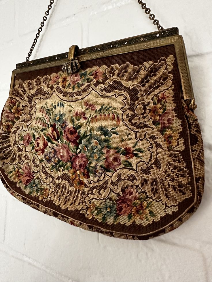 This vintage 1930s Austrian Needlepoint Purse is beautifully crafted. The bag is still in its authentic vintage condition.  While a few jewels may be missing, the purse's overall allure is undiminished, making it a stunning addition to any collection. The intricate Austrian needlepoint design speaks to the craftsmanship of a bygone era, ensuring that this purse is not just an accessory, but a timeless work of art. Please take a look at the pictures for more details.  Measurements 10 inches with chain  6 Inches from clasp to bottom of purse/ without chain 7.5 inches in width  Please message if you need more details. Thank you! Vintage Rectangular Bags For Vintage Events, Vintage Rectangular Bags For Events, Vintage Evening Bag For Vintage Events, Antique Rectangular Bags For Vintage Fashion, Vintage Rectangular Evening Bag, Vintage Brown Pouch Evening Bag, Vintage Formal Shoulder Bag, Antique Handmade Bags For Vintage Events, Handmade Antique Bags For Vintage Events