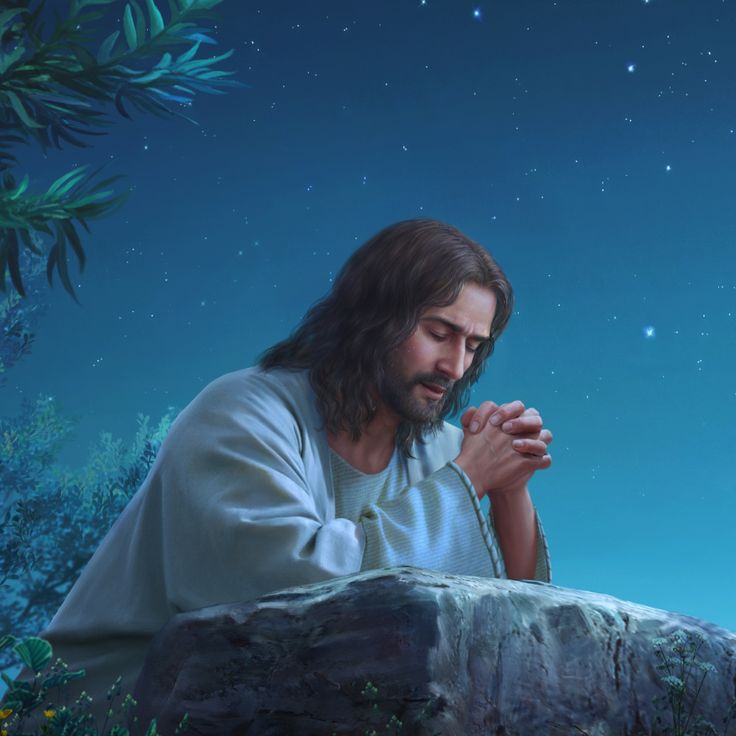 jesus sitting on a rock with his hands folded and praying in front of the stars