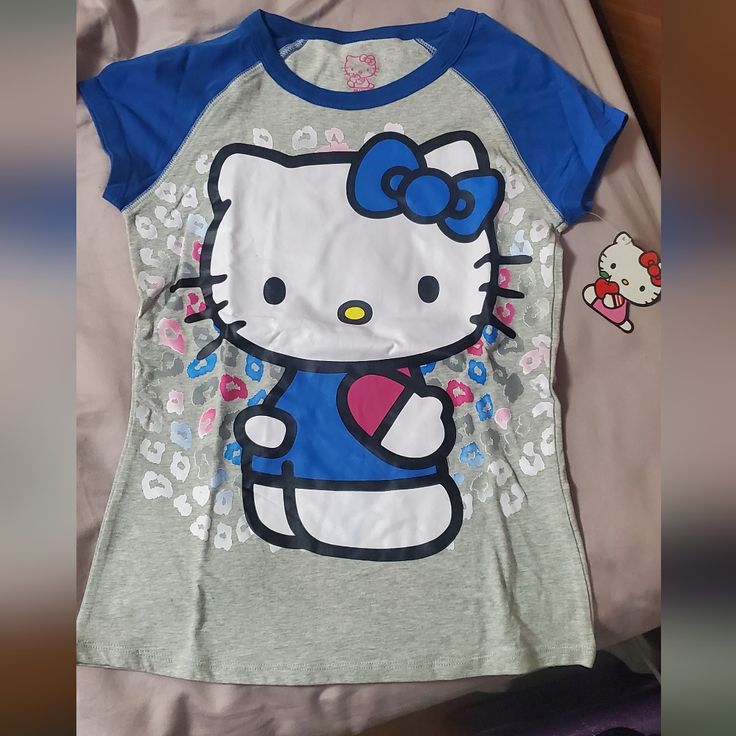 New Hello Kitty Tee Hello Kitty Baby Tee, Blue Cotton Top With Cat Print, Blue Casual Top With Cat Print, Casual Blue Cat Print Top, Casual Blue Tops With Cat Print, Blue Casual T-shirt With Cat Print, Casual Blue T-shirt With Cat Print, Blue Hello Kitty Print Short Sleeve Top, Blue Short Sleeve Top With Hello Kitty Print