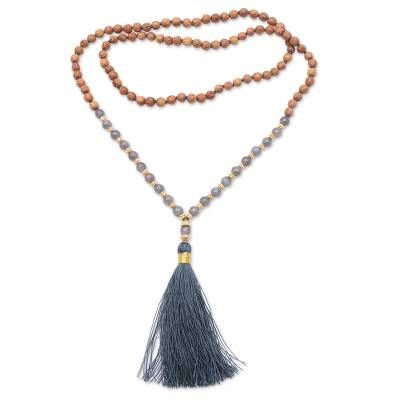 By Ketut Sulastri in Bali this bohemian necklace celebrates the beauty of nature's gifts. Beads of mala wood encircle the neck centered by alternating labradorite and 22k gold plated sterling silver beads. A grey tassel forms the pendant of this necklace. Spiritual Wooden Beads Jewelry For Meditation, Brown Bohemian Mala With 108 Beads, Bohemian Brown Mala With 108 Beads, Spiritual Wooden Beads Jewelry For Healing, Spiritual Wooden Beads Necklace For Meditation, Natural Round Beaded Jewelry For Festivals, Holistic Style Necklace With Wooden Beads, Holistic Wooden Beads Necklace As A Gift, Holistic Style Necklace With Wooden Beads For Gifts