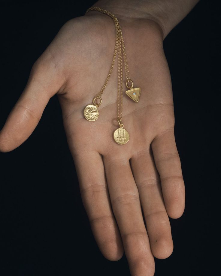 Representing renewal and adaptability, this solid gold coin necklace bears a classical profile with an octopus motif on the reverse. Suspended from a 14k curb chain, this double-sided pendant is made from pure 24k gold offering a rich, tactile lustre that is eternally timeless.  
 Each piece is crafted by hand, ensuring that every necklace is unique. Gold Coin Pendant, Gold Coin Necklace, Coin Bracelet, Coin Pendant Necklace, Triangle Pendant, Diamond Guide, Gold Coin, Coin Necklace, Engagement Ring Wedding Band