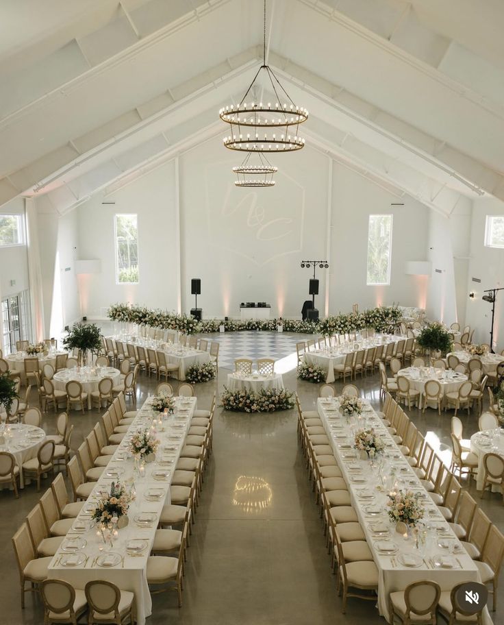 a large banquet hall with tables and chairs set up for an event or wedding reception