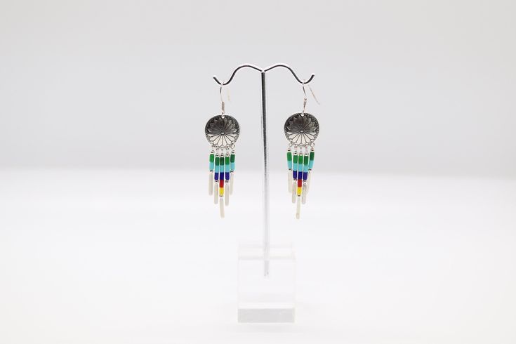 These beautiful silver dangle earrings are multi-colored. They are a great addition to any outfit. Elegant Multicolor Metal Beaded Earrings, Rainbow Metal Earrings With Ear Wire, Rainbow Metal Earrings, Multicolor Metal Dangle Jewelry, Elegant Multicolor Nickel-free Beaded Earrings, Colorful Nickel-free Dangle Beaded Earrings, Elegant Multicolor Nickel-free Crystal Earrings, Nickel-free Colorful Dangle Beaded Earrings, Rainbow Nickel-free Drop Earrings