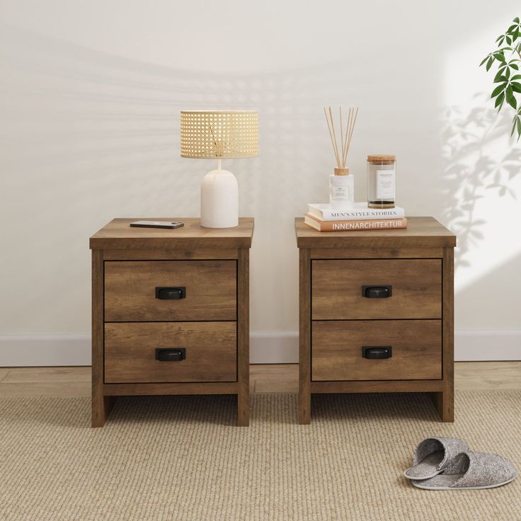 two nightstands side by side with shoes on the floor next to them and a plant