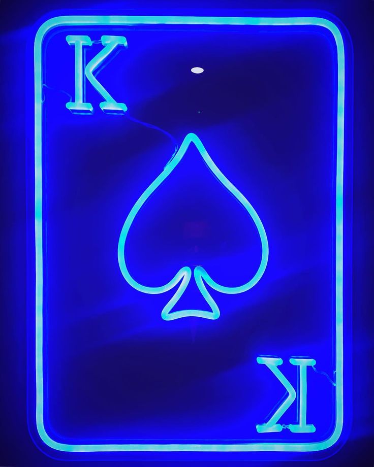 a neon blue playing card with the letter k in it's center and an ace symbol on top