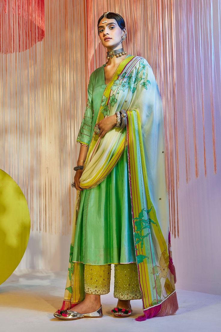 Sea green kurta with side kalis and placement embroidered motifs. Comes with lime green palazzo and ivory dupatta.
Components:3
Pattern:Embroidery
Type of Work:Beads, Sequin, Gota Patti and Thread
Neckline:V neck
Sleeve Length:Flared
Fabric:Silk, Modal Satin and Crepe
Color:Green,Pink
Other Details:
Sleeves with bead drops
Dupatta with striped border and fringe
Embroidered palazzo
Occasion:Wedding - Aza Fashions Pink Anarkali, Kurta Palazzo Set, Silk Anarkali, Embroidery Beads, Traditional Attires, Latest Dress Design, Traditional Indian Dress, Indian Dresses Traditional, Palazzo Set