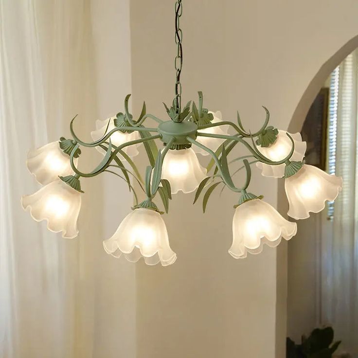 a chandelier with white flowers hanging from it