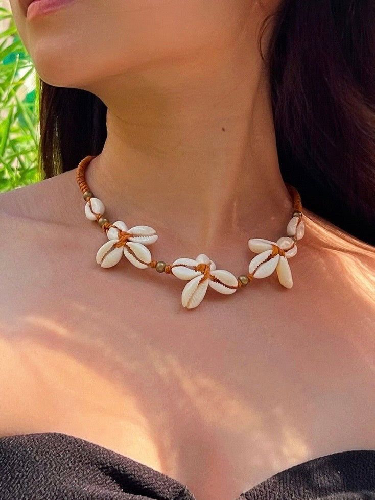 Flower Cowrie Seashell Choker Necklace Handmade Flower Jewelry For Vacation, Shell Choker Jewelry As A Gift, Handmade Beaded Necklaces With Mother Of Pearl, Adjustable Handmade Shell Beaded Necklaces, Adjustable Beaded Shell Necklaces, Bohemian Resizable Strand Jewelry, Handmade Cowrie Shell Necklaces For Gifts, Shell Strand Choker As A Gift, Natural Cowrie Shell Jewelry As Gift