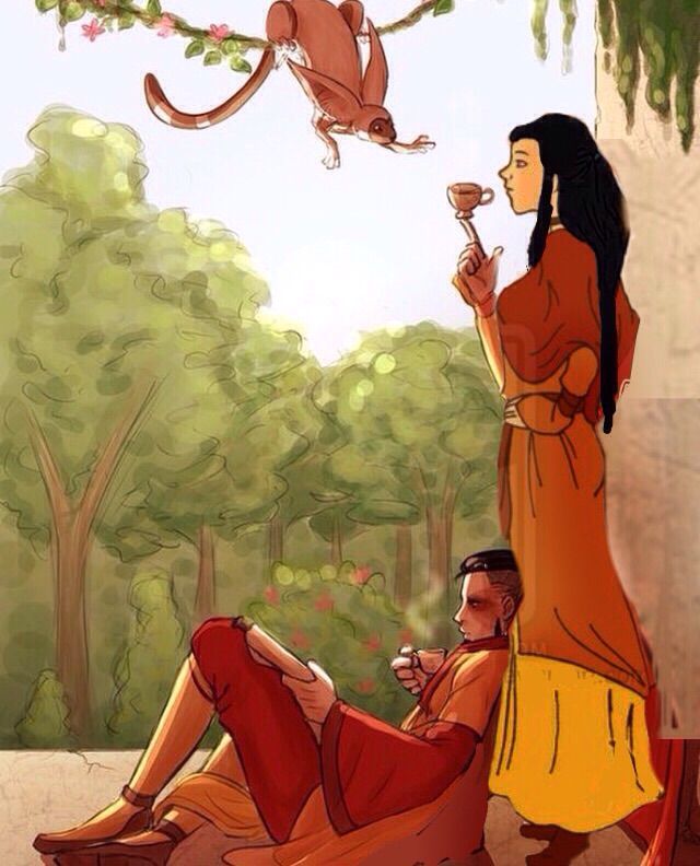 a woman sitting on the ground next to a man with a monkey hanging from a tree